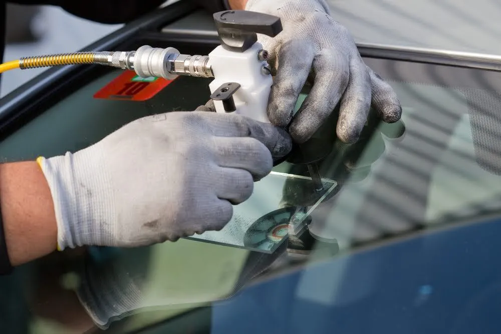 Technician repairing a windscreen chip in Caboolture